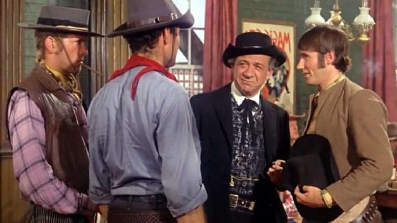A scene from Carry On Cowboy showing four men in a wild west street