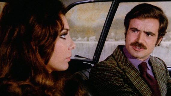A still from the film Gang War in Milan. A man and a woman in a car.